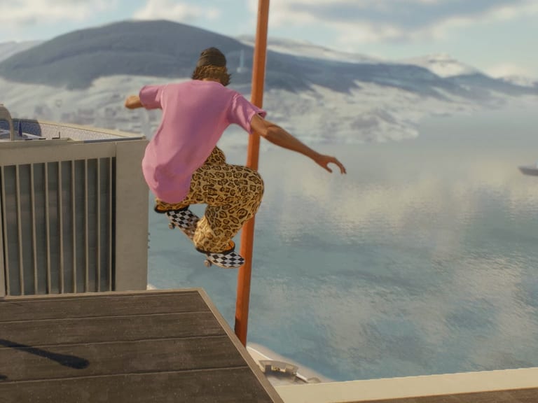 Gameplay from skate.: a skater in a pink tee launches off a tower rooftop, with the ocean and mountains behind.